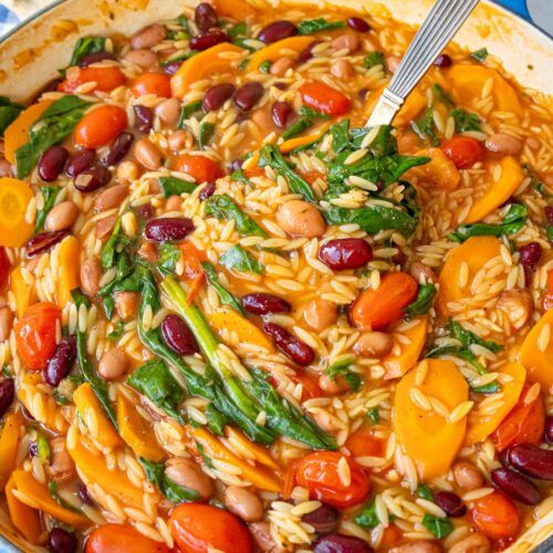 Finished orzo and beans close up showing creamy texture with spinach and tomatoes 1