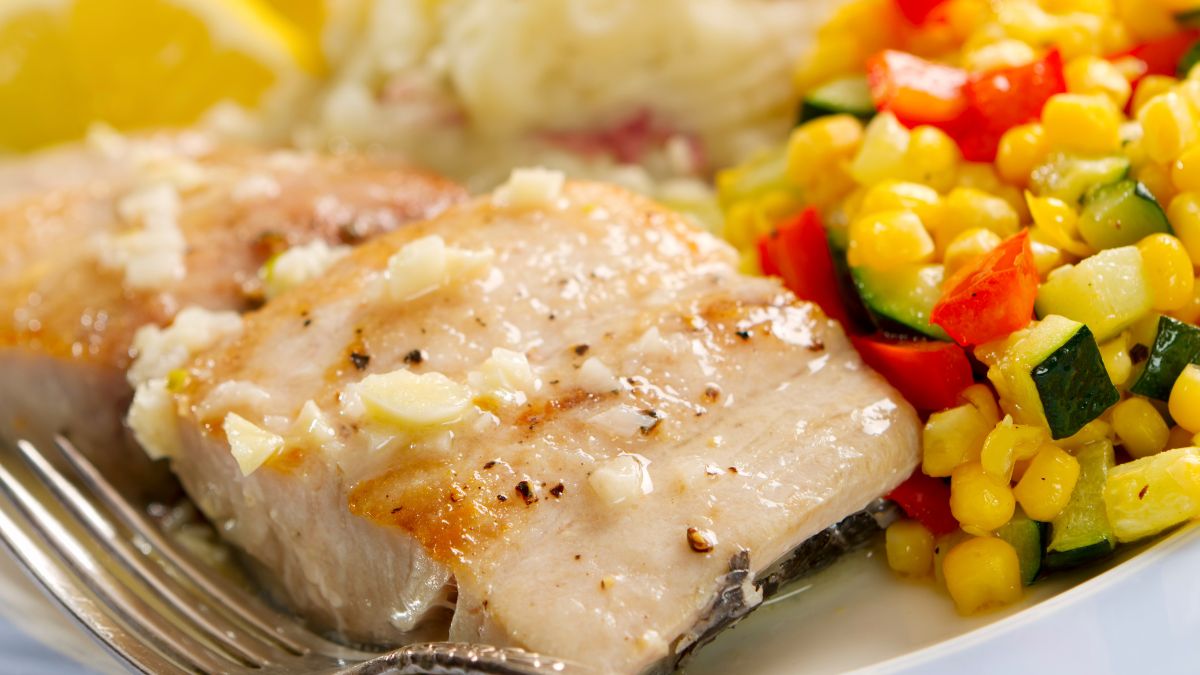 Fresh Pan Seared Mahi Mahiin a garlic and lemon pan sauce served with mashed potatoes and a vegetable medley of corn, bell pepper, and squash
